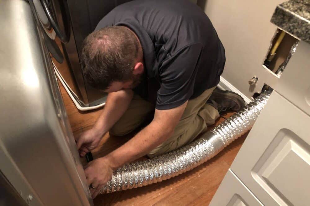 Dryer Vent Cleaning - A professional technician performing dryer vent cleaning services to ensure safety and efficiency.