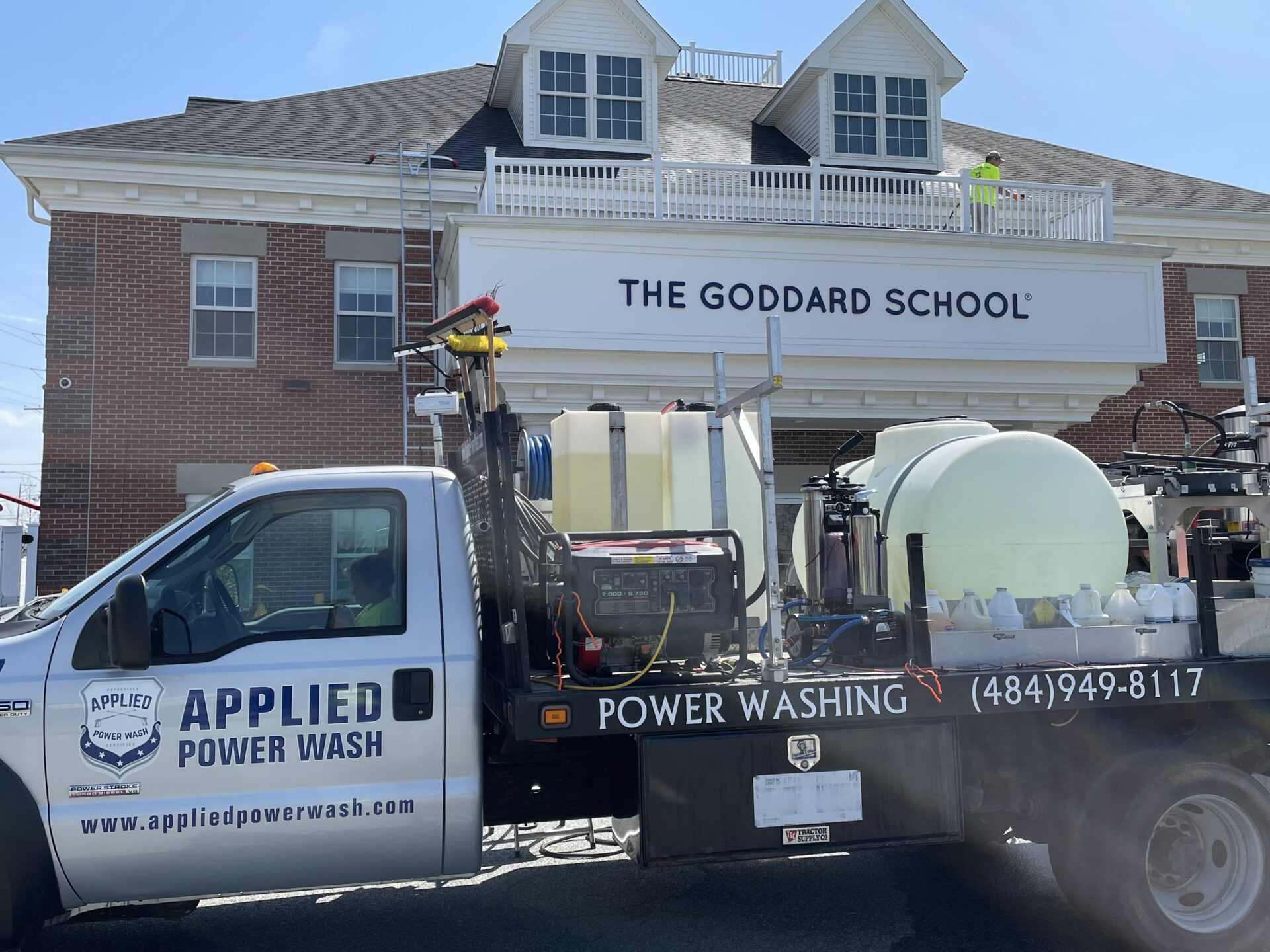 The Goddard School 1 Cobble Brick Driveway Pressure Washing by Worker.